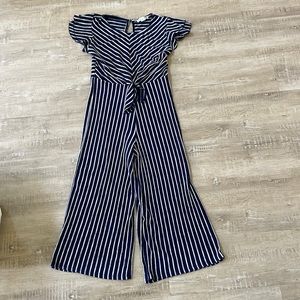 This is a navy and white stripped jumpsuit! It is by knit works and is a kids 14